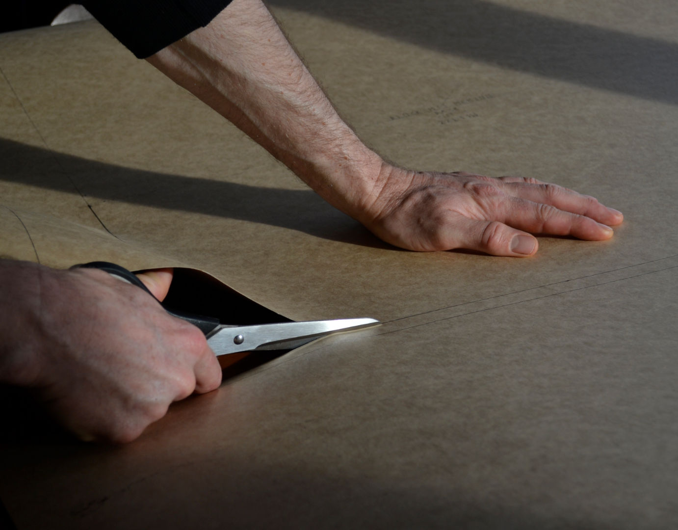 Cutting paper patterns for a Wild Balance hoodie.