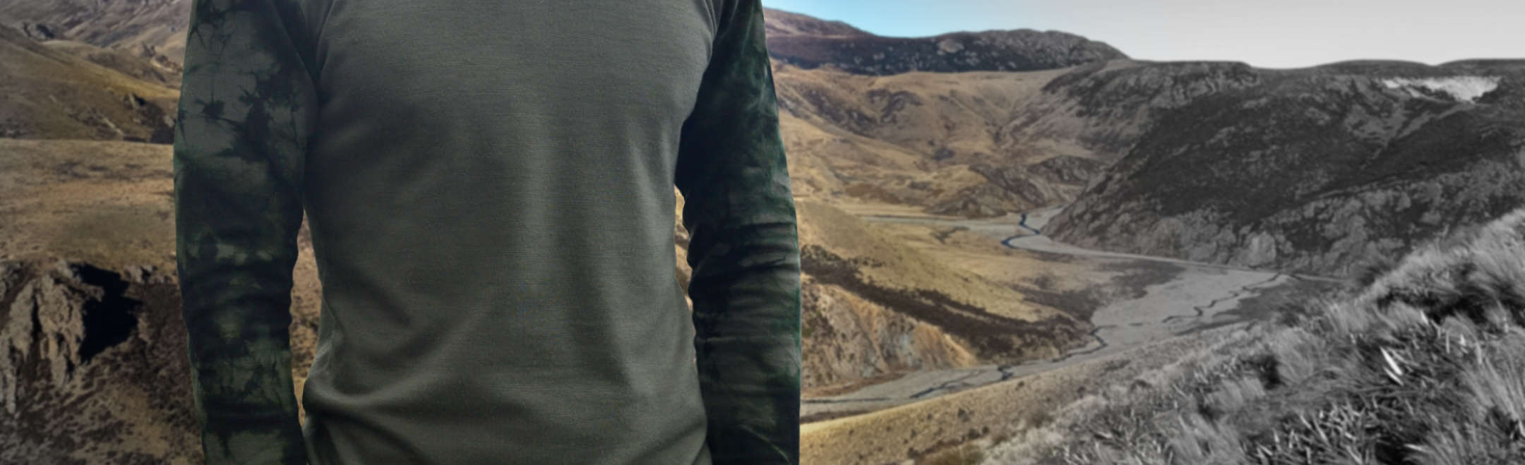 Placeholder image of a hunter in a hoodie standing in front of a rock wall.